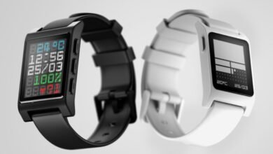 Black and white Pebble smartwatches displayed against a light gray background. One watch shows various data points.