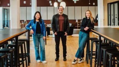 Partovi and his two partners at Neo, Suzanne Xie and Emily Cohen., stand in a modern office, smiling at the camera. Two women flank a man in the center.