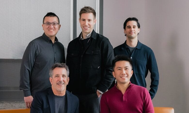 Five men, the Cheehoo founders, stand for a photo in business casual attire against a neutral background.