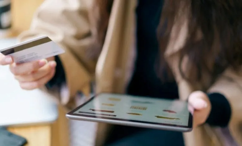 Business woman holding Tablet and magnetic card