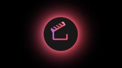 A minimalist logo: a pink and red clapperboard glows in a dark circle on a black background.