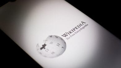 Close-up of a smartphone displaying the Wikipedia logo and tagline: 'The Free Encyclopedia'.