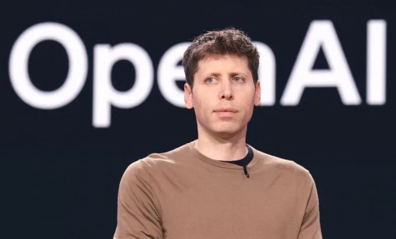 Sam Altman, OpenAI CEO, stands against a dark background with the OpenAI logo.