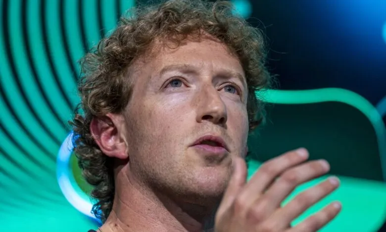 Close-up of Mark Zuckerberg, Meta CEO, speaking at a conference. He's gesturing with his hand against a teal background.