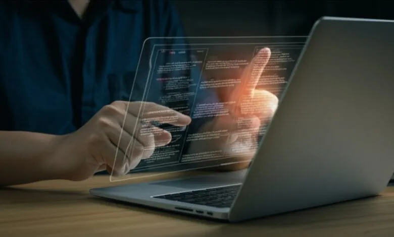 Person's hands interact with a glowing laptop screen displaying text, suggesting AI assistance in writing.