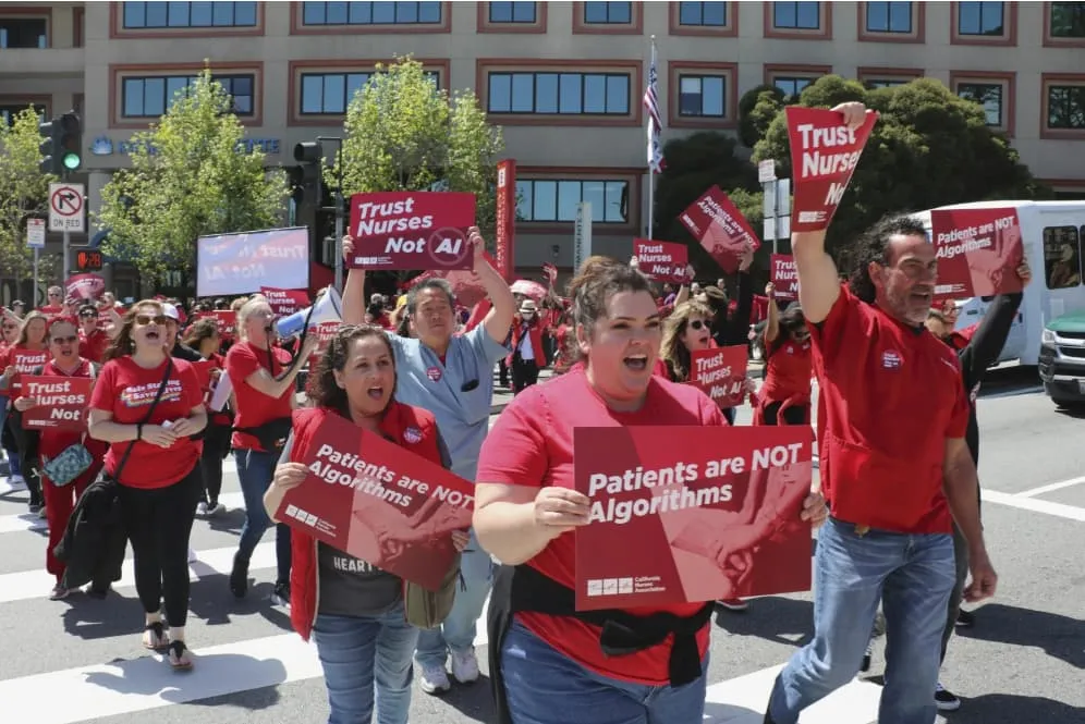 In-this-photo-provided-by-National-Nurses-United-nurses-hold-a-rally-in-San-Francisco-on-April-22-2024-to-highlight-safety-concerns-about-using-artificial-intelligence-in-health-care In-this-photo-provided-by-National-Nurses-United-nurses-hold-a-rally-in-San-Francisco-on-April-22-2024-to-highlight-safety-concerns-about-using-artificial-intelligence-in-health-care