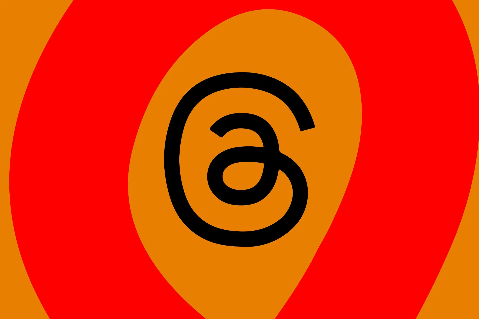 Abstract graphic with a large black '@' symbol centered on an orange background, surrounded by red and orange concentric circles.