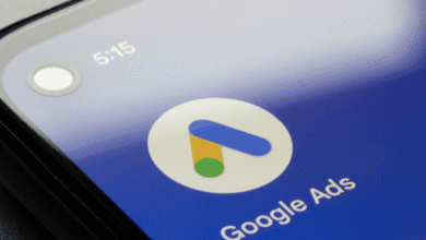 Close-up of a smartphone displaying the Google Ads app icon and text on a blue background.