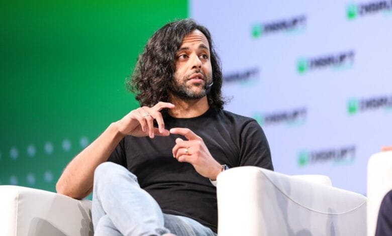 Baiju Bhatt, co-founder of Robinhood, speaks at a conference, gesturing with his hands.