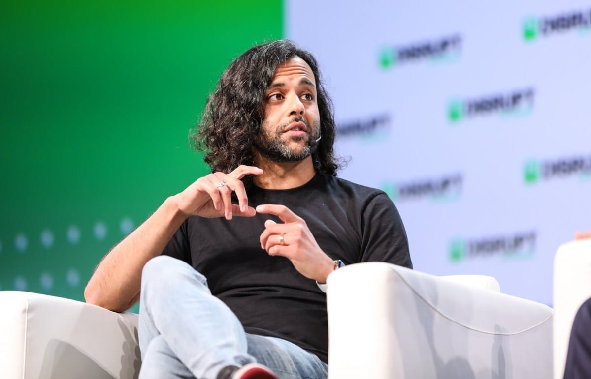 Baiju Bhatt, co-founder of Robinhood, speaks at a conference, gesturing with his hands.