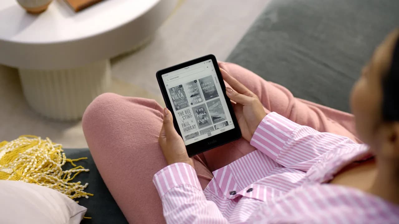 Girl holding Amazon Kindle device