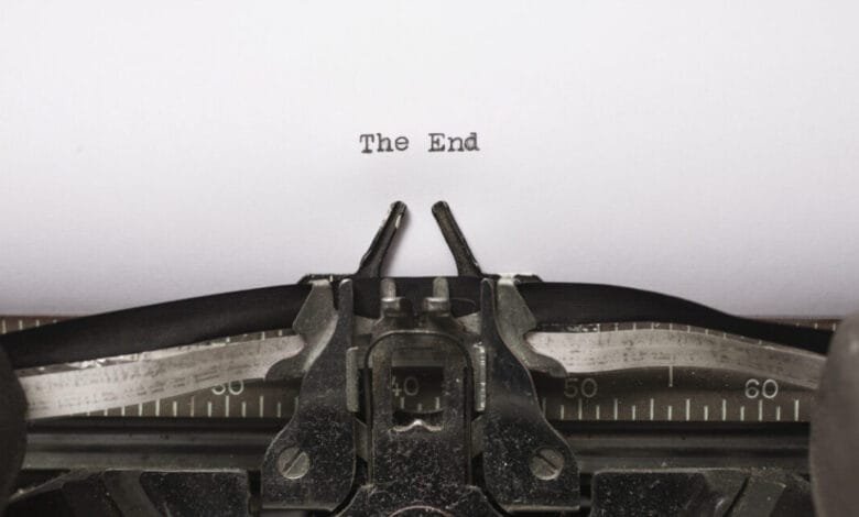 Close-up of a vintage typewriter with the words 'The End' typed on the page.