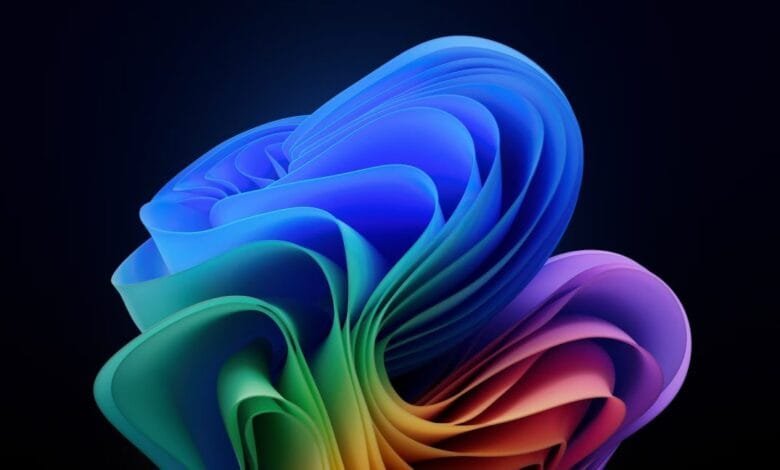 Abstract rainbow-colored swirls on a black background, resembling folded fabric or petals.