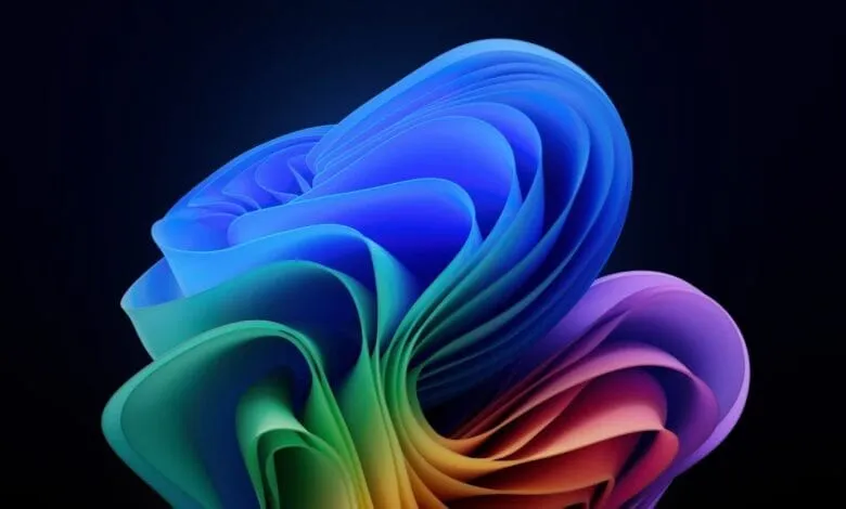 Abstract rainbow-colored swirls on a black background, resembling folded fabric or petals.