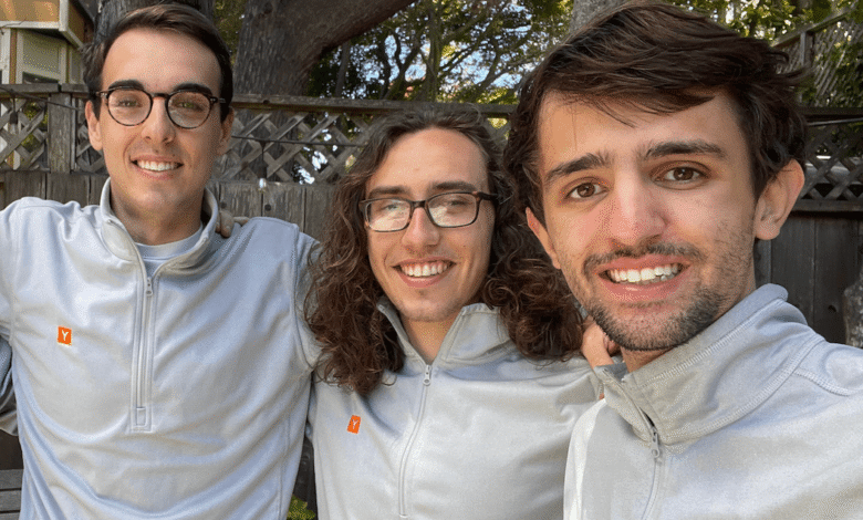 Firecrawl-founders: Eric Ciarla, Caleb Peffer, Nicolas Silberstein Camara in gray quarter-zip shirts stand outdoors, arms around each other.