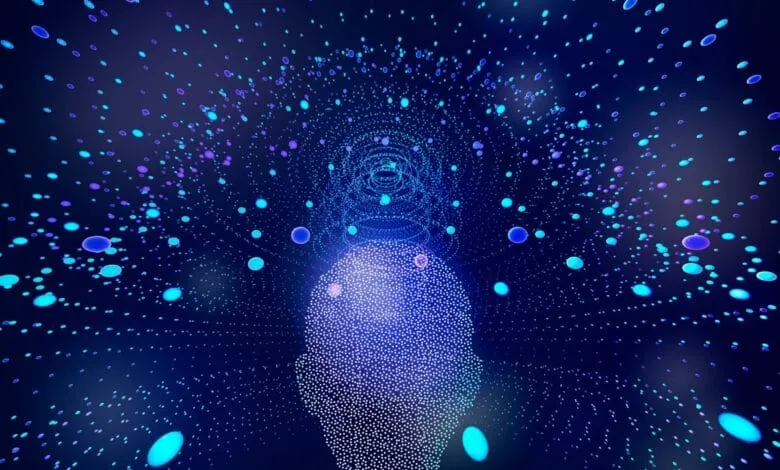 Abstract digital art depicting a head formed from glowing particles, with more particles radiating outwards.