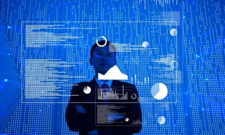 Businessman stands confidently before a digital screen displaying graphs, charts, and data visualizations in shades of blue.