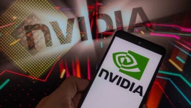 A smartphone displays the NVIDIA logo against a vibrant background featuring the NVIDIA name and a microchip graphic.