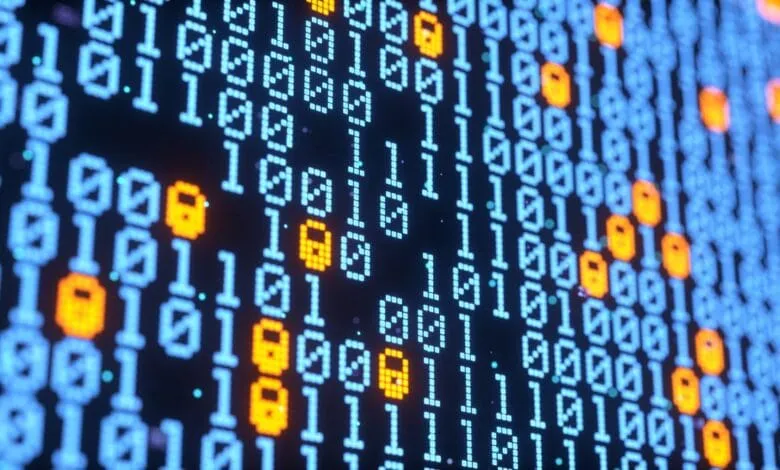 Close-up of a digital screen displaying binary code with glowing orange padlock symbols interspersed, suggesting data security.