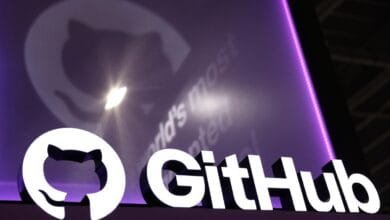 GitHub logo: 3D white lettering and cat icon on purple backdrop. A blurred logo projection is behind it.