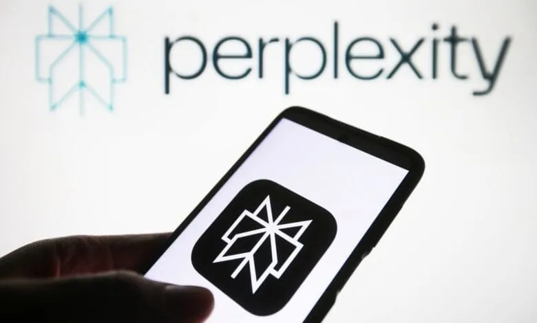 Close-up of a smartphone displaying the Perplexity AI app logo against a blurred background showing the Perplexity AI company logo.