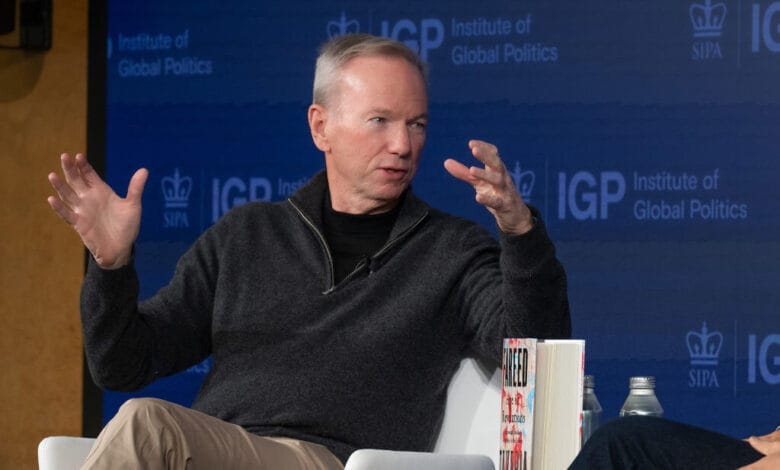 Eric Schmidt, former Google CEO, speaks passionately at a Columbia University event, gesturing with his hands.
