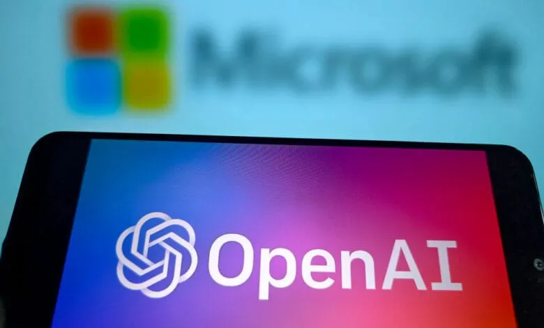 Smartphone displays OpenAI logo; blurred Microsoft logo in background.