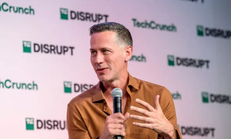George Fraser, CEO of Fivetran, speaks at TechCrunch Disrupt, holding a microphone and gesturing.