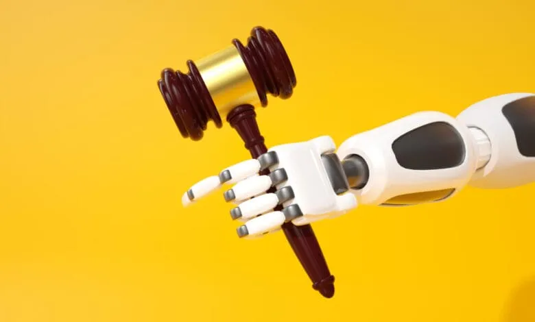 Robotic hand holds a gavel against a yellow background, symbolizing AI in law.