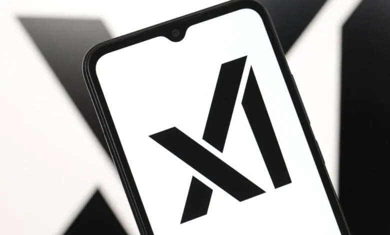 Close-up of a smartphone displaying the xAI logo: a bold black stylized 'X' on a white screen.