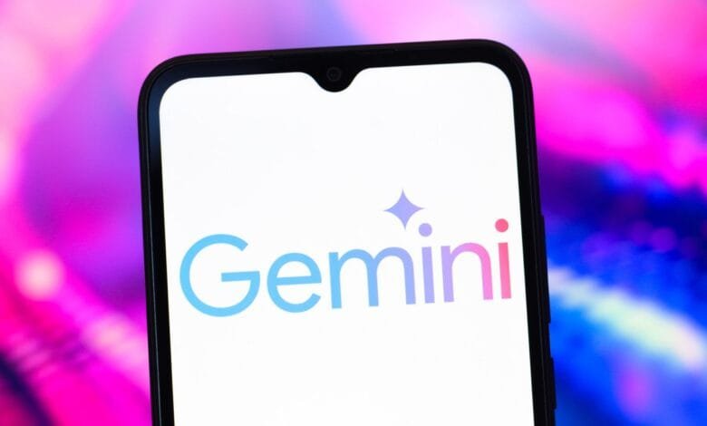 Close-up of a smartphone displaying the Gemini cryptocurrency exchange logo: a light blue and purple wordmark with a small star.