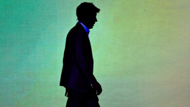 Silhouette of Sam Altman, OpenAI CEO, walking away from a teal and green textured background.
