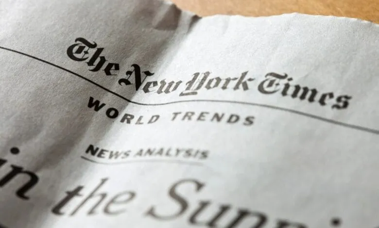 Close-up of a crumpled New York Times newspaper, showing the headline 'World Trends' and part of a story.