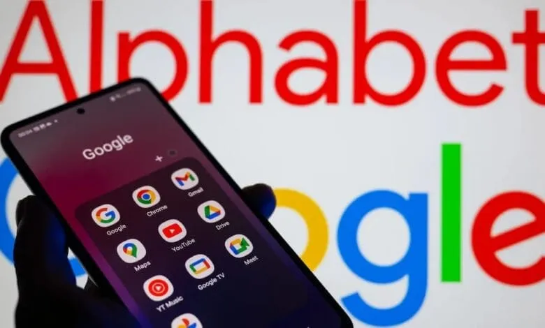 A mobile phone with app folder open on Google products. in the background we read: Google Alphabet