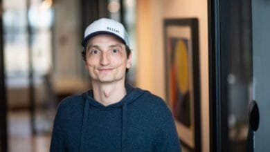 Nicolas Kopp, Founder and CEO of Rillet, smiles gently in a modern office hallway.