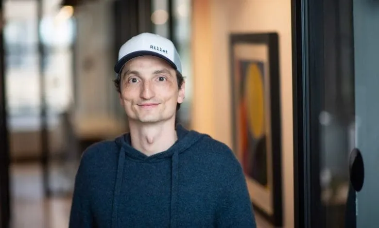 Nicolas Kopp, Founder and CEO of Rillet, smiles gently in a modern office hallway.