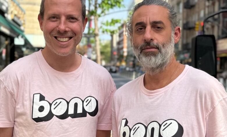 Ron and Dan Bono stand on a city street.