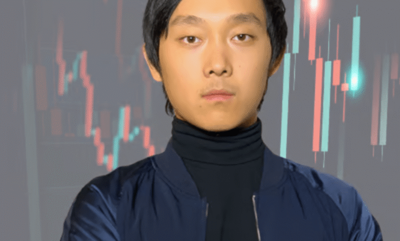 Young man, Steven Wang, with arms crossed, serious expression, standing before a background of stock market candlestick charts.