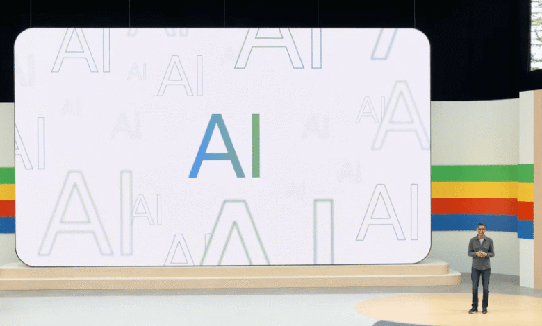 A large screen displays the letters AI repeatedly in various sizes and shades of blue and green, a person stands on a stage in front of it.