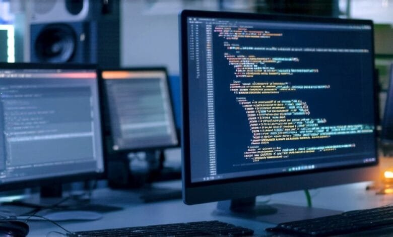 Close-up of computer screens displaying lines of code, suggesting software development or programming.