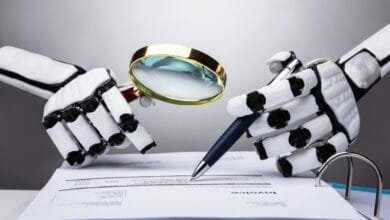 Robotic hands examine an invoice with a magnifying glass and pen, highlighting AI's role in auditing.