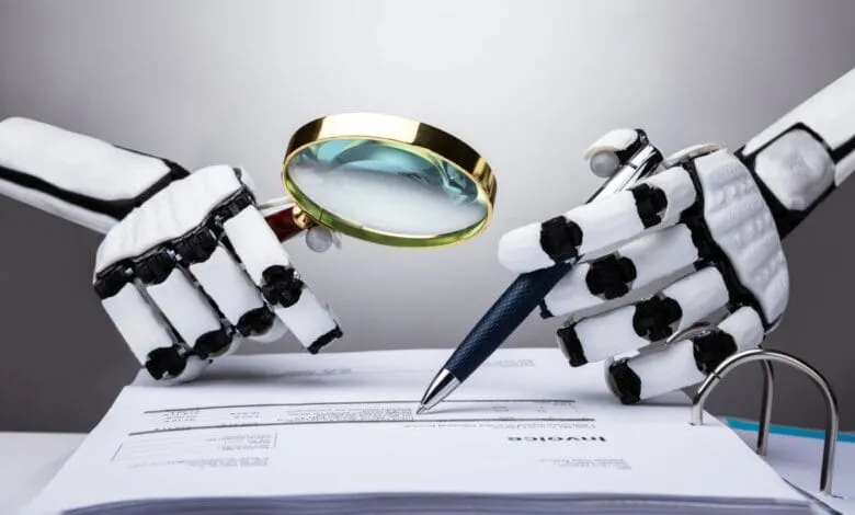 Robotic hands examine an invoice with a magnifying glass and pen, highlighting AI's role in auditing.