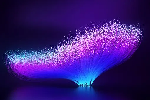 Abstract artwork of glowing purple and blue fiber optic strands forming a wave-like shape against a dark background.