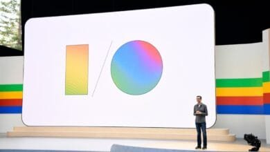 A man presents at Google I/O; a large screen displays the Google I/O logo.