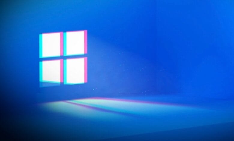 Stylized Windows 11 logo with glitch effect; pink and teal outlines on a deep blue background.