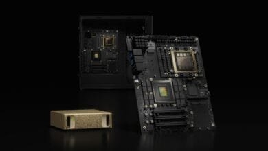 Close-up of NVIDIA DGX system components: black circuit boards with gold processors, and a gold storage unit.