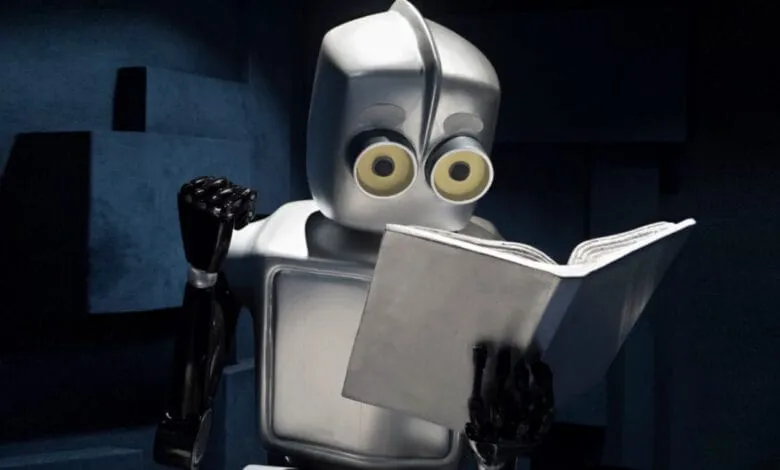 A silver robot with large, expressive eyes sits in a dark room, engrossed in reading a book.