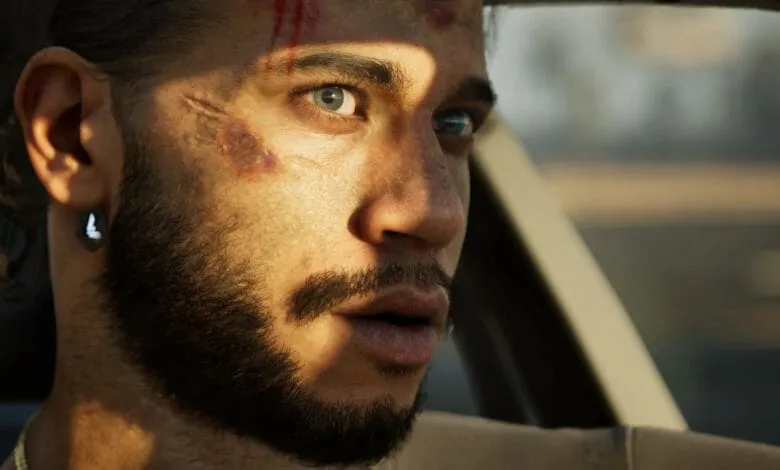Close-up of a man's face, showing scrapes and bruises, looking out a car window.