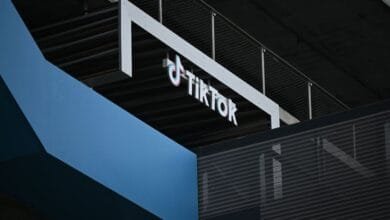 TikTok logo on a modern building exterior, showcasing a sleek design with blue and black accents.