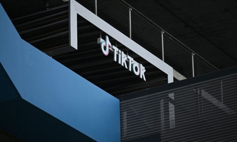 TikTok logo on a modern building exterior, showcasing a sleek design with blue and black accents.
